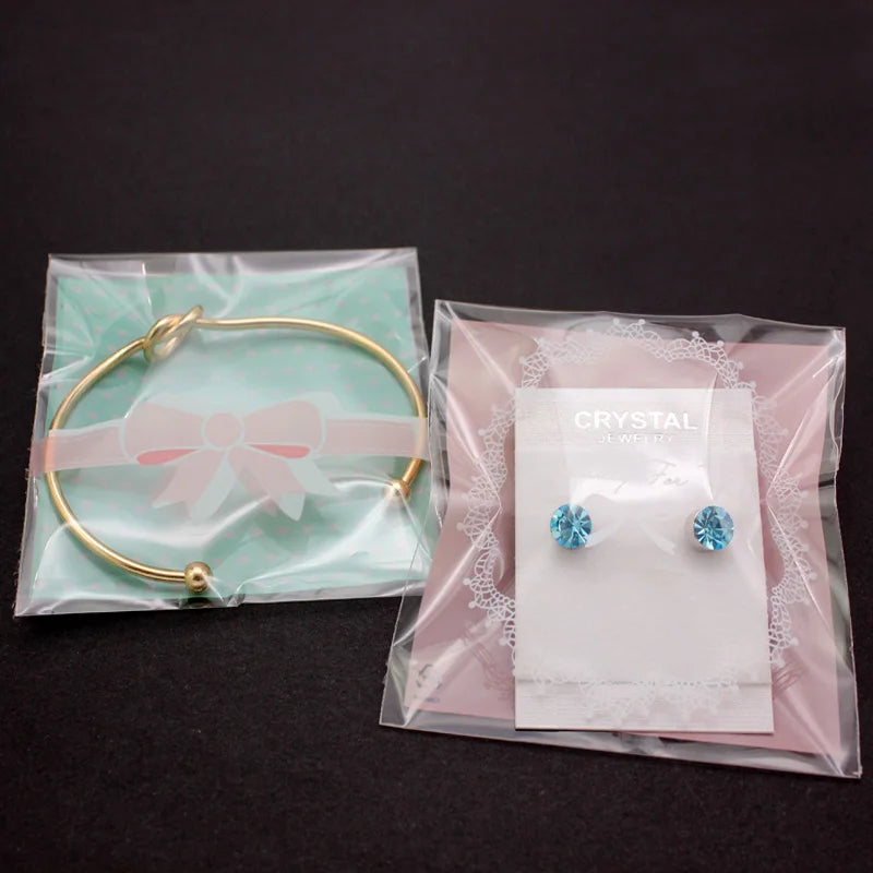 100PCS OPP Plastic Package Lovely Bowknot Design for Bracelets Earrings Necklace Rings DIY Jewelry Making 7 X 7cm